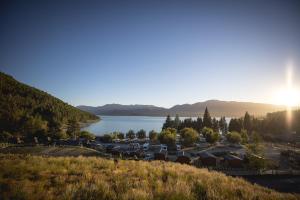 a large body of water with a mountain range at Lakes Edge Holiday Park in Lake Tekapo