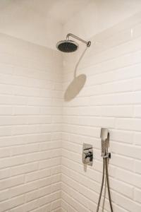 a shower with a shower head in a bathroom at The berg's 2 in Ocna-Mureşului