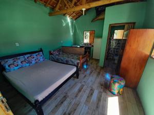 A bed or beds in a room at Chalés e Camping Taquaral