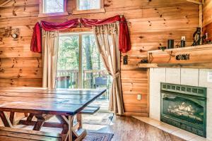 a dining room with a table and a fireplace at Mama Bear's Moonshine Ridge in Gatlinburg
