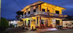 a yellow building with lights on top of it at Hostal Romy in Puerto Baquerizo Moreno