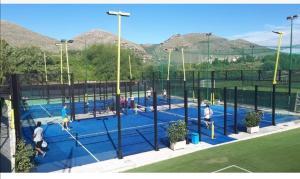 a group of people playing tennis on a tennis court at Federico 70 Zaffiro Luxury in Palermo