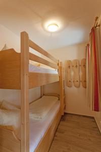 a couple of bunk beds in a room at Amadeus Appartement in Sankt Johann in Tirol