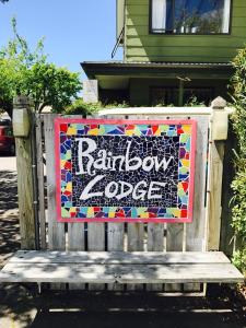 a wooden bench sitting on top of a sidewalk at Rainbow Lodge Backpackers in Taupo