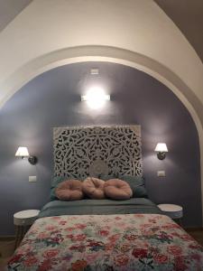 a bedroom with a bed with two pillows on it at L'Angolo dei Cavalieri in Pisa