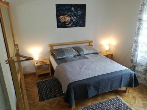 a bedroom with a bed with two lamps on it at Willa Stary Dom in Warsaw