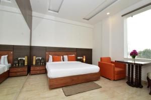 Postel nebo postele na pokoji v ubytování Hotel Bhaskar