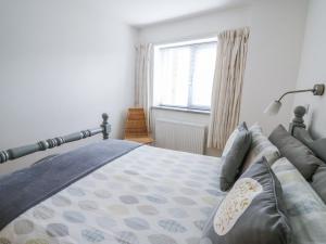 a bedroom with a bed and a window at The Mushroom House in Tenby