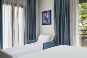 A bed or beds in a room at NLH KERAMEIKOS - Neighborhood Lifestyle Hotels