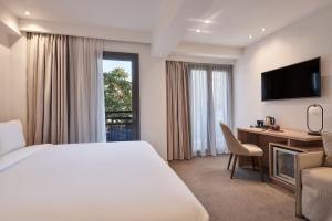 A bed or beds in a room at NLH KERAMEIKOS - Neighborhood Lifestyle Hotels