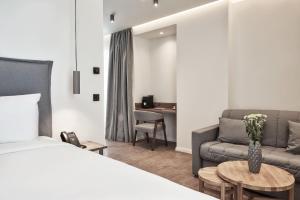 A bed or beds in a room at NLH KERAMEIKOS - Neighborhood Lifestyle Hotels