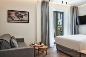 A bed or beds in a room at NLH KERAMEIKOS - Neighborhood Lifestyle Hotels