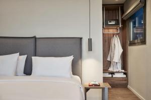 A bed or beds in a room at NLH KERAMEIKOS - Neighborhood Lifestyle Hotels