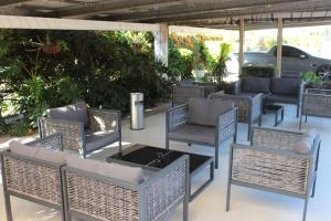 a group of chairs and tables on a patio at Golden Harvest Motor Inn Moree in Moree
