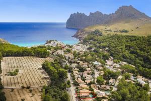 an aerial view of a town next to the ocean at Villa Ramis by JS Villas in Cala de Sant Vicenc