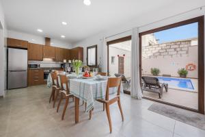 a kitchen and dining room with a table and chairs at Sa Placeta new reformed large town house with pool in Sa Pobla