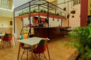 a restaurant with tables and chairs and a counter at Batians Apartment Hotel in Nairobi