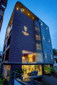 a building with a tres sign on the side of it at The Trios Hotel in Cochin