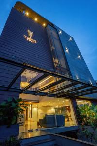 a building with a sign on the side of it at The Trios Hotel in Cochin