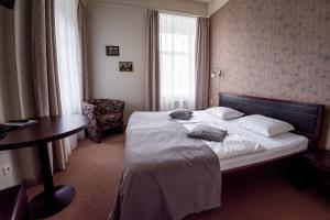 a hotel room with a bed and a desk at Hotel Sigulda in Sigulda