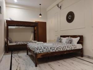 a bedroom with two beds and a mirror at The Karauli Villa by Le Pension Stays in Jaipur