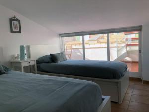 2 Betten in einem Zimmer mit Balkon in der Unterkunft AR27-5 Amplio ático en primera línea del casco antiguo in Villajoyosa