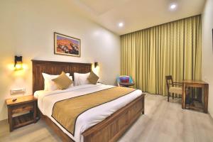 a bedroom with a large bed and a desk in it at RUDRA VILAS - A Royal Heritage Hotel in Jaipur +15 photos