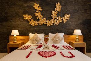 a bedroom with a bed with two swans on it at Kutus Kutus Canggu Villa in Canggu