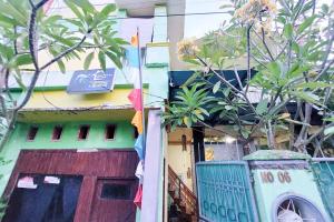 a building with a door and a sign on it at Quattrick Dee Homestay Mitra RedDoorz in Manokwari