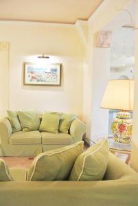 a living room with a couch and a table at Hotel Mignon in Forte dei Marmi