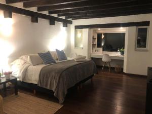 1 dormitorio con 1 cama y escritorio con TV en Casa San Angel Inn Boutique charming house, en Ciudad de México