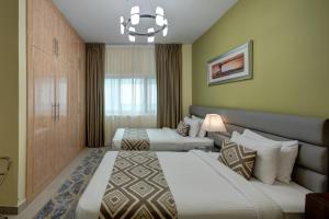 a hotel room with two beds and a large window at Radiance Premium Suites in Dubai
