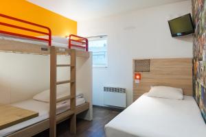 a small room with two bunk beds and a television at hotelF1 Igny Massy TGV in Igny