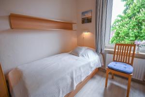 Ένα ή περισσότερα κρεβάτια σε δωμάτιο στο Zur schönen Aussicht - FW 9