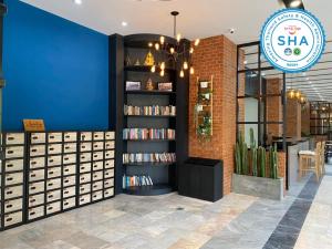 a bookstore with a book shelf filled with books at Jomtien Longstay Hotel - SHA Plus Certified in Jomtien Beach