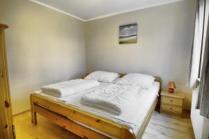 a bedroom with a bed with two pillows on it at Robbe FW 4 in Zingst