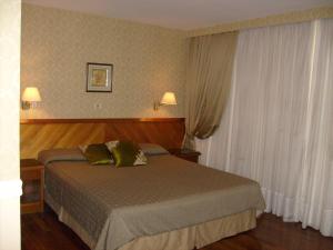 Säng eller sängar i ett rum på Premier Hill Suites Hotel