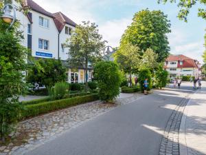 a street in a town with people walking and buildings at Strandstraße 51 Whg 1 in Zingst