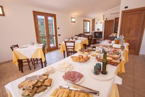 a room with several tables with food on them at Agriturismo Benza in Imperia +12 photos