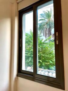 a window with a view of a palm tree at ARTEMIS 1 Bdr Down Town Nicosia By Platform 357 in Nicosia