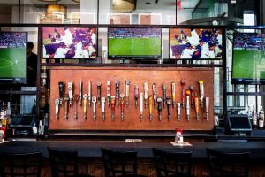 a bar with a display of baseball bats at Wyndham Garden Chinatown in New York