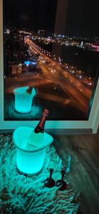 a bottle of wine in a bowl and a glass at Квартира в Академ Риверсайд с панорамным видом in Chelyabinsk