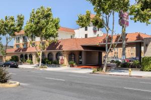 a building with a red roof on a street at Best Western Plus South Bay Hotel in Lawndale