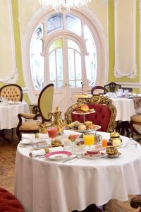 a table filled with plates of food and drinks at Palacete Chafariz Del Rei - by Unlock Hotels in Lisbon