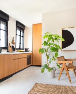 a kitchen with a potted plant and a table at AYA Boutique Aparthotel in Tel Aviv
