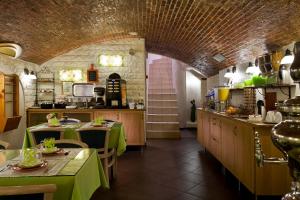 une cuisine avec deux tables et un tissu de table vert dans l'établissement Hôtel Aurore Paris Gare de Lyon, à Paris