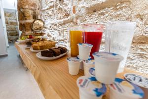 a long table with drinks and pastries on it at Khalisah in Palermo