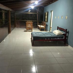 a bedroom with a bed and a tiled floor at RANCHO SAPUCAÍ in Passos