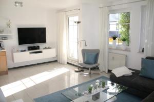 a living room with a couch and a tv at Strandstraße 21 Whg 5 in Zingst