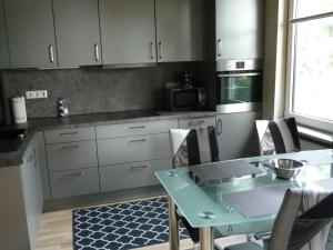 a kitchen with a table with chairs and a microwave at Wohnung "Doppelspitze" in Hohenhameln